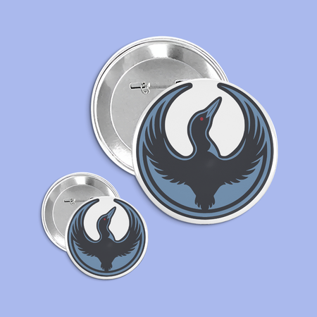 Two buttons with a black loon design on a blue background