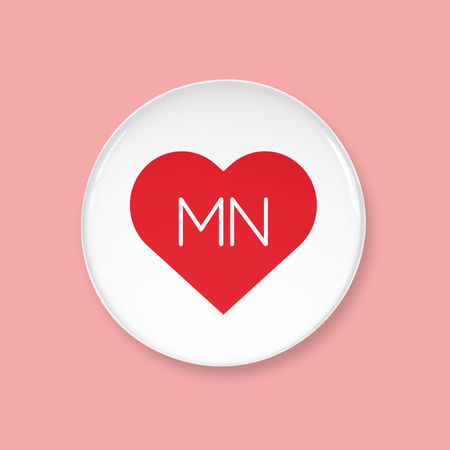 Round white button with a red heart and 'MN' text on a pink background