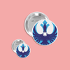 Two buttons with a blue and white loon on a pink background