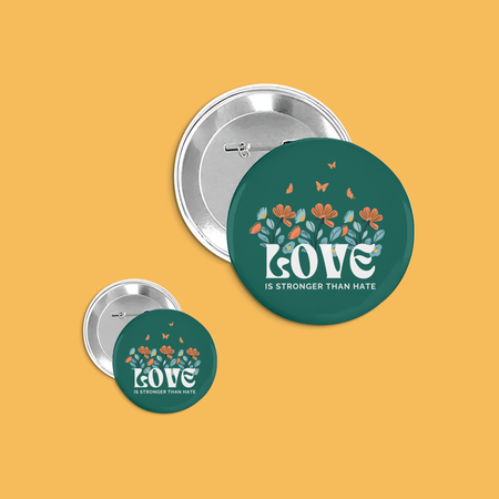Two buttons with 'Love is Stronger than Hate' design on a yellow background