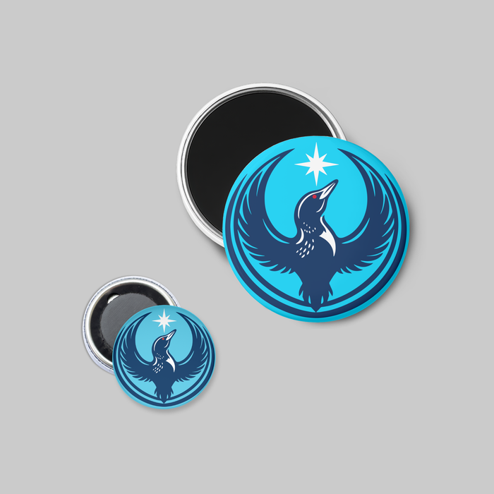 Two circular blue magnets with a loon design on a gray background